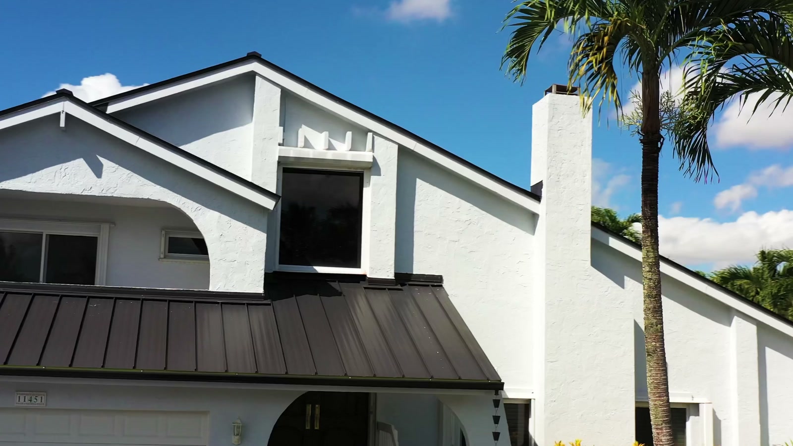 Completed metal roof and white exterior