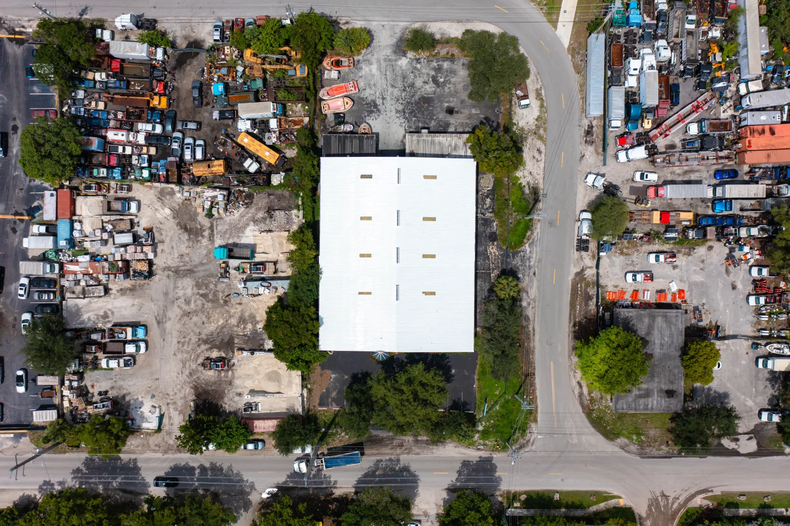 Professional aerial view of a completed white commercial metal roof from the Acosta project archive.