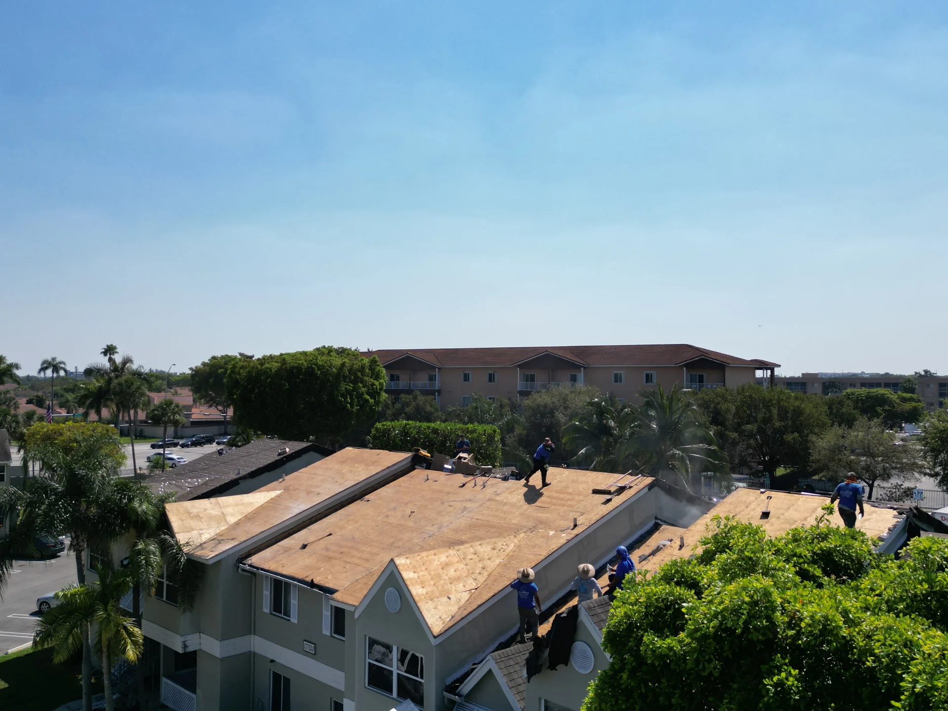 Exposed roof decking above an Antigua townhome during roofing work
