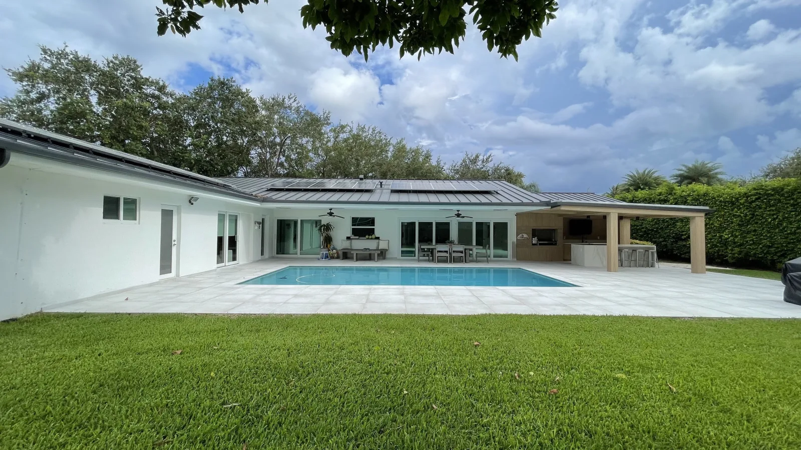 Completed Bruno pool, deck, outdoor kitchen and landscaped backyard.