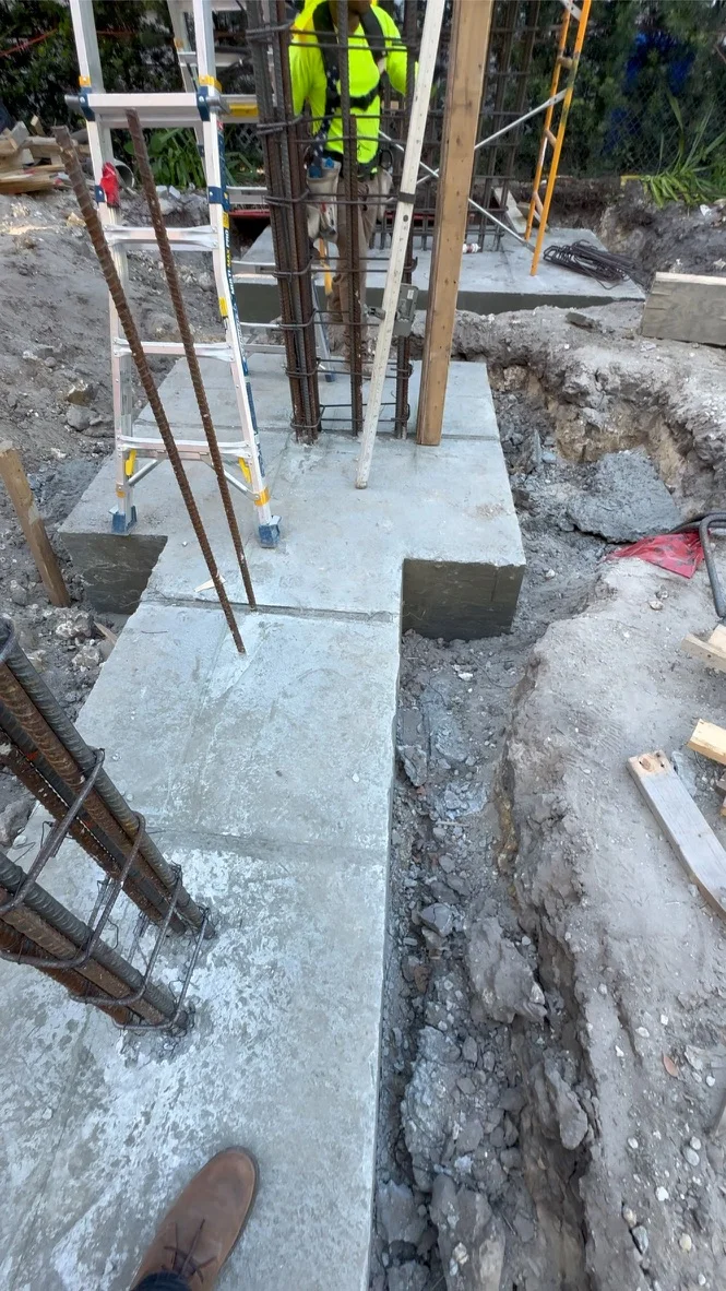 Concrete footing and vertical reinforcing cages documented during the Leslie House custom-home build.
